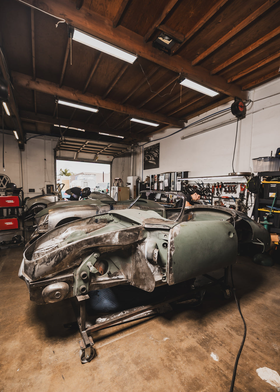 Porsche 356 bare-metal body panel restoration on the Washburn's Metal shop floor