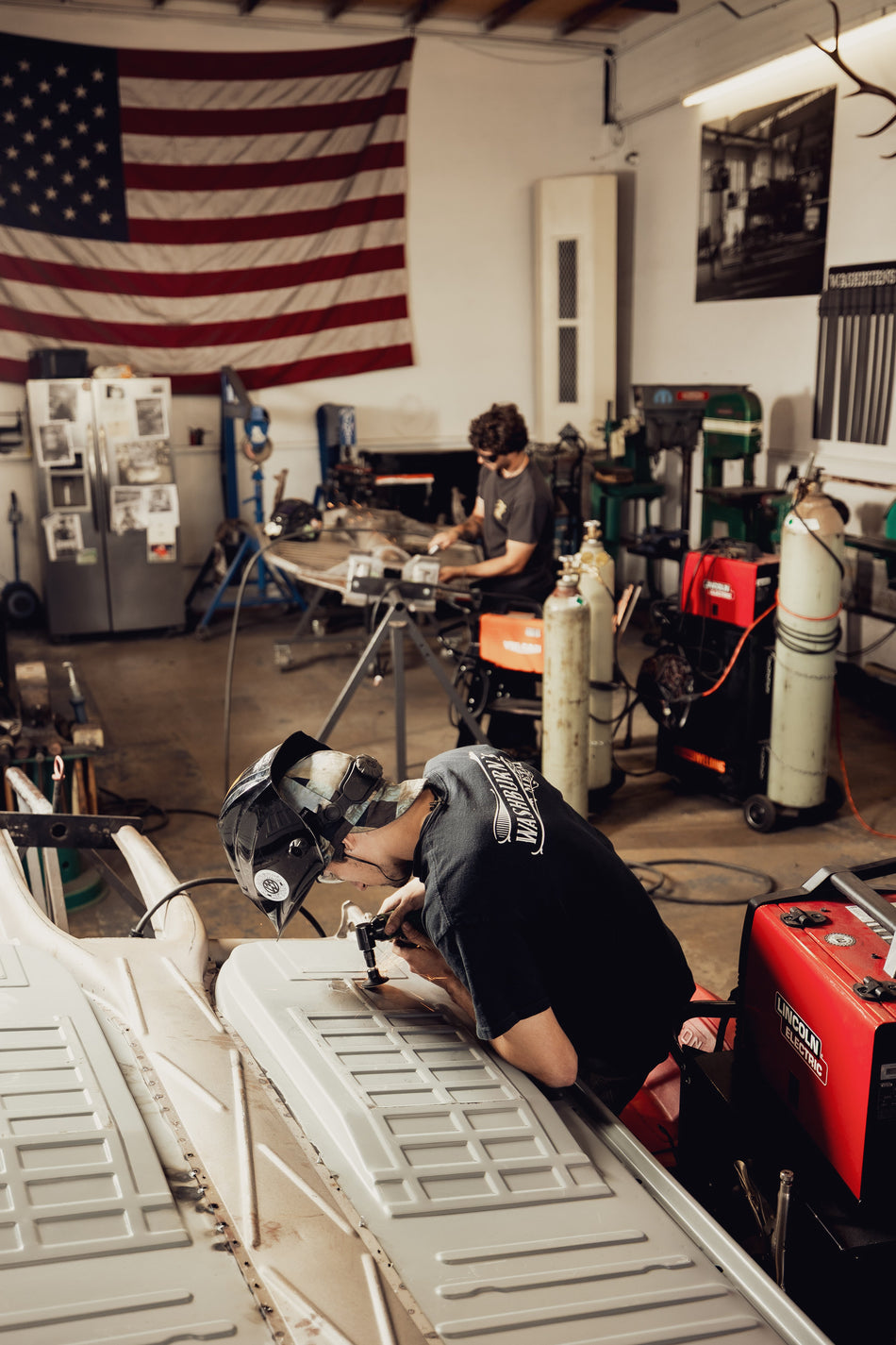 Washburn's Metal technician welding a VW floor panel in the Orange, CA shop