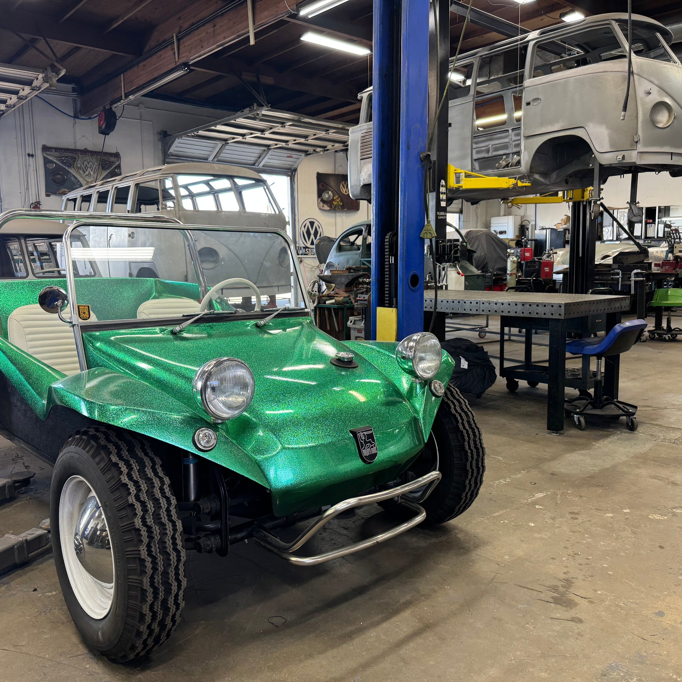 Green-sparkle Meyers Manx dune buggy in the Washburn's Metal shop