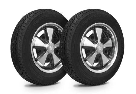 EMPI 10-2022-0 911-style black/polished 5.5x15 wheel with Yokohama 165/80R15 tire, 5x205 wide-5, for 1950-1967 VW Beetle, 1956-1966 Karmann Ghia and 1956-1963 Porsche 356A/356B (high-resolution) — shown with EMPI's crest-style center cap marked EMPI (not a Porsche part)