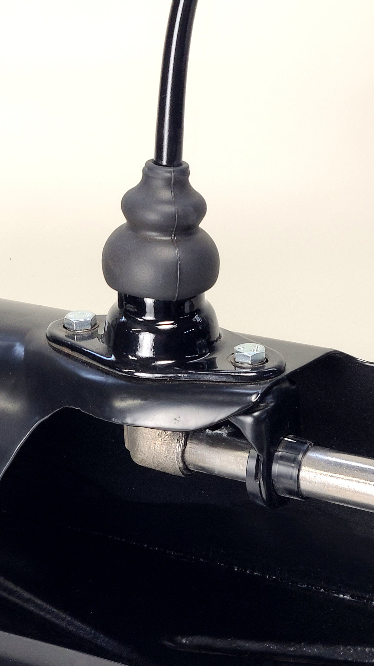 Snap-Lock Delrin shift bushing pair shown with mounting bracket for demonstration