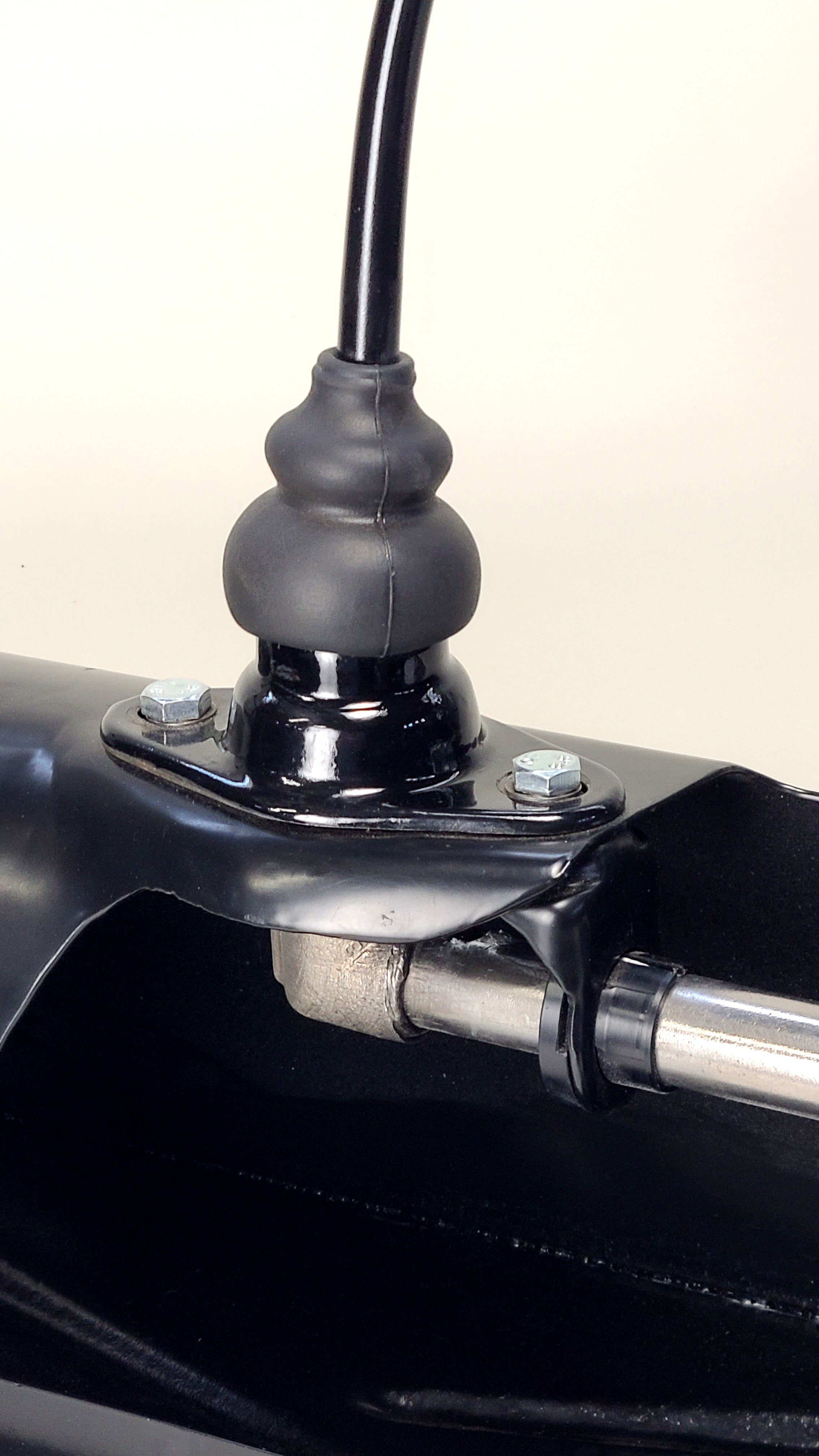 Snap-Lock Delrin shift bushing pair shown with mounting bracket for demonstration