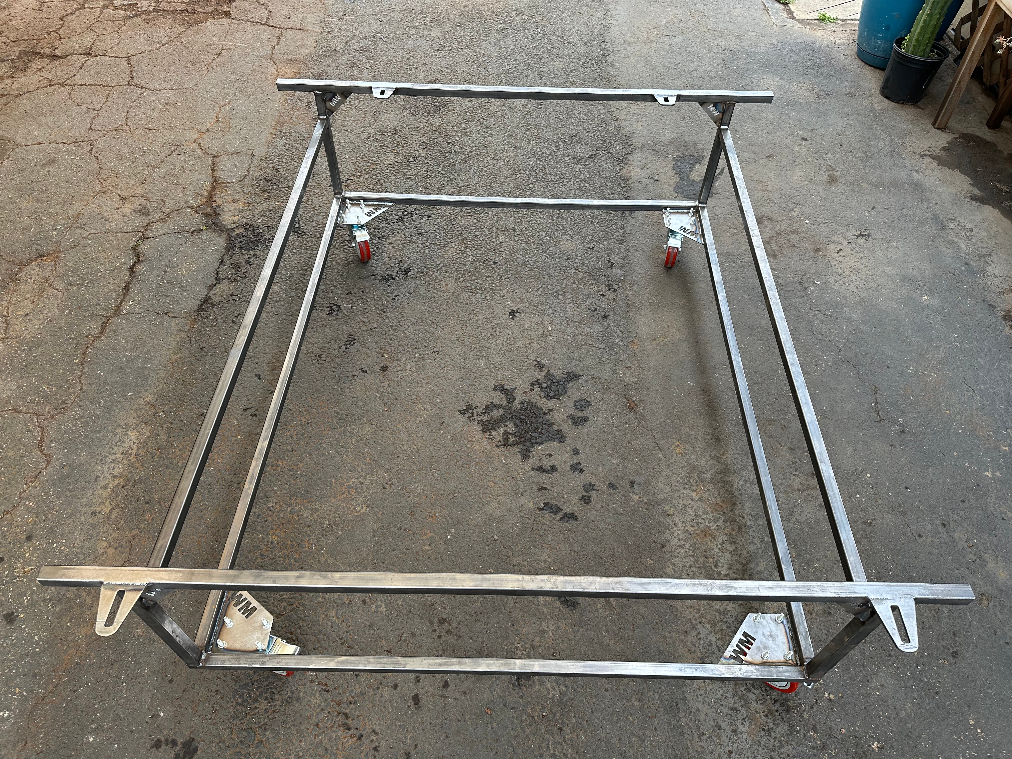 VW body cart supporting stripped Beetle body during restoration — Washburn's Metal shop