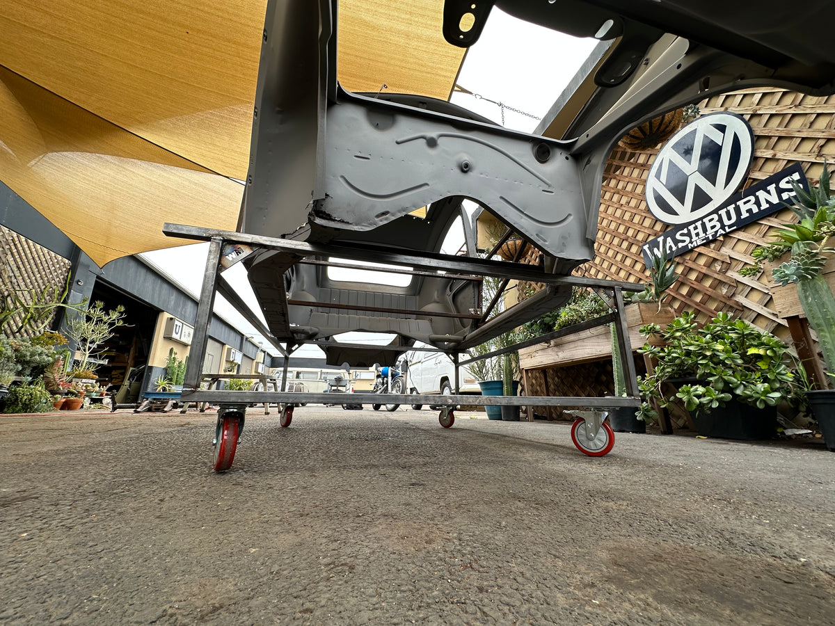 Body cart kit unwelded parts laid out — steel tubing, wheels, and hardware before assembly