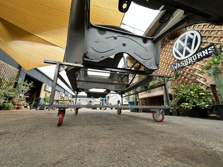 Body cart kit unwelded parts laid out — steel tubing, wheels, and hardware before assembly